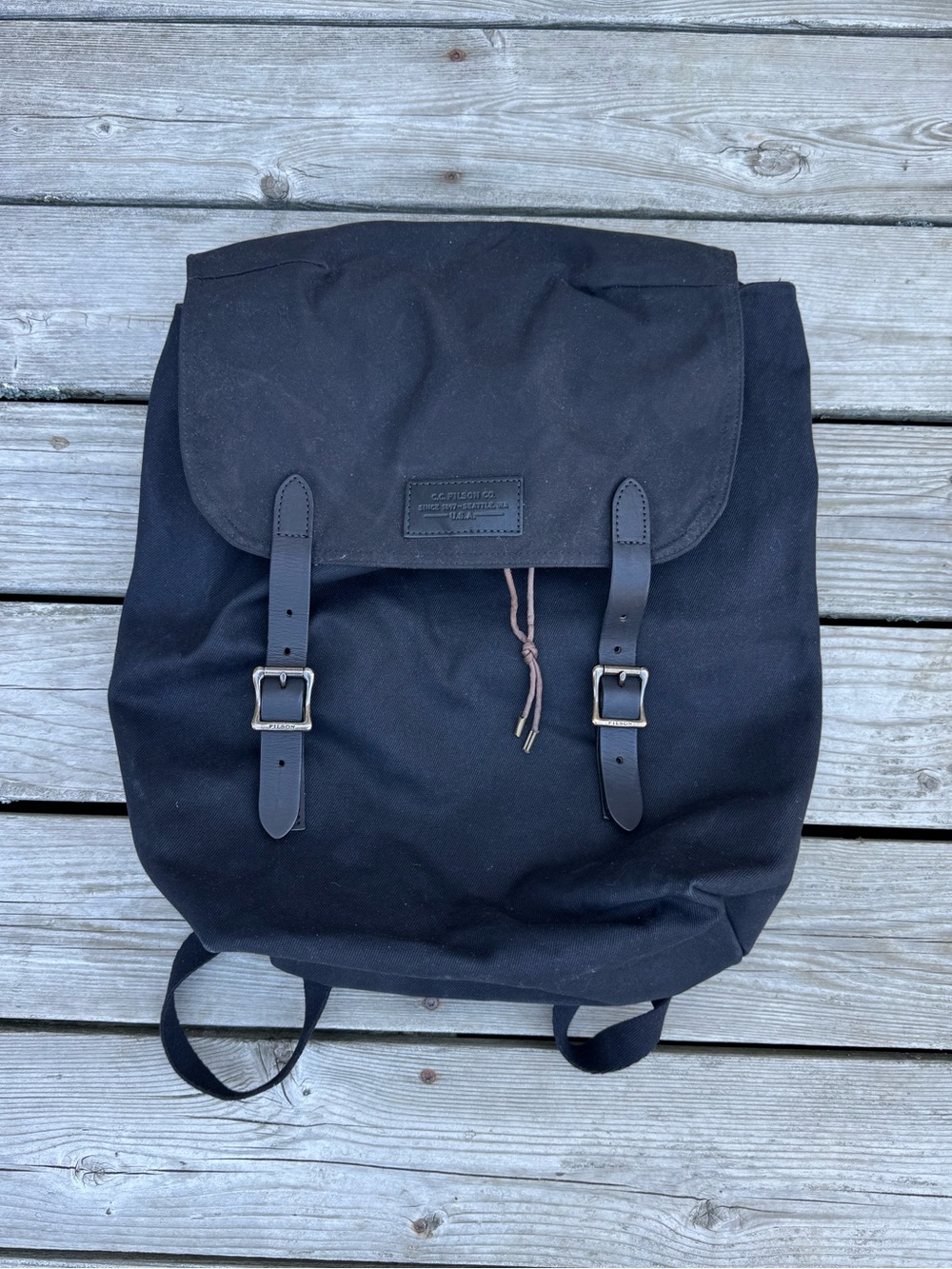 Filson canvas backpack with leather and brass buckle
